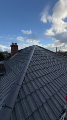New grey tiled roof with hip and ridge system
